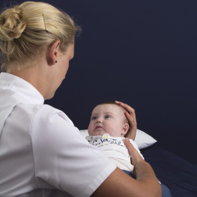 Baby receiving cranial osteopathy